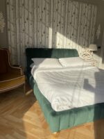Letto matrimoniale schienale curvo imbottito con cuciture verticali verde antimacchia